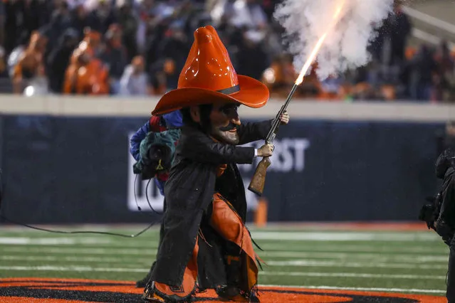 Oklahoma State's mascot fires a shotgun before an NCAA college football game against Cincinnati Saturday, October 28, 2023 in Stillwater, Okla. (Photo by Mitch Alcala/AP Photo)
