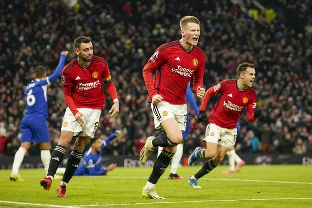 Manchester United's Scott McTominay, center, celebrates after scoring his side's second goal during the English Premier League soccer match between Manchester United and Chelsea at Old Trafford stadium in Manchester, England, Wednesday, December 6, 2023. (Photo by Dave Thompson/AP Photo)