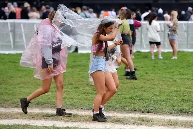 Festival goers put on ponchos as the rain falls on Day 1 of Leeds Festival 2021 at Bramham Park on August 27, 2021 in Leeds, England. (Photo by Matthew Baker/Getty Images)