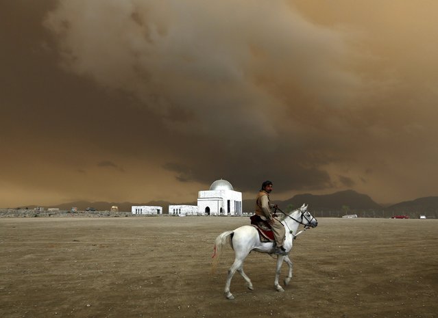 A man rides a horse at a playground on a hill in Kabul April 19, 2015. (Photo by Mohammad Ismail/Reuters)