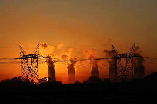 Electricity pylons are seen in front of the cooling towers at the Lethabo Thermal Power Station,an Eskom coal-burning power station near Sasolburg in the northern Free State province,March 2, 2016. (Photo by Siphiwe Sibeko/Reuters)