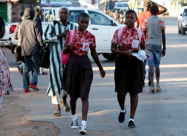 Two school girls walk at Kairaba avenue in Banjul, Gambia January 24, 2017. (Photo by Thierry Gouegnon/Reuters)