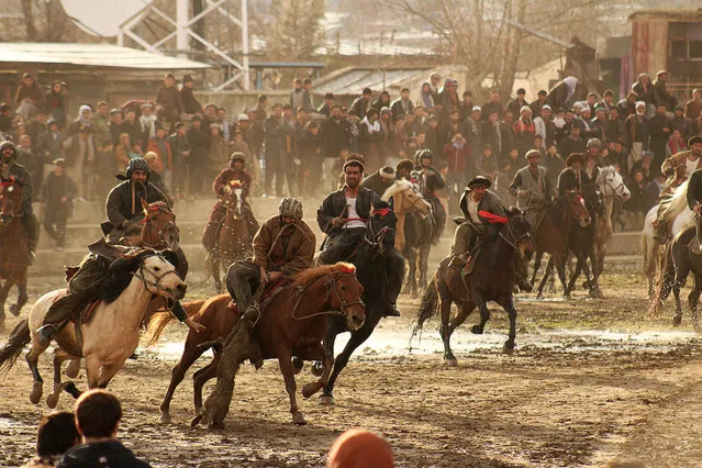 In this photo taken on February 19, 2018, Afghan horsemen compete during a game of the traditional sport of Buzkashi, in Badakhshan province. The ancient game of Buzkashi is an Afghan national sport which is played between two teams of horsemen competing to throw a animal carcass into a circle. (Photo by Sharif Shayeq/AFP Photo)