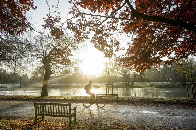 A cyclist rides by the river Avon during a bright and frosty morning in St Nicholas' Park in Warwick, UK on Wednesday, December 6, 2023. (Photo by Jacob King/PA Images via Getty Images)