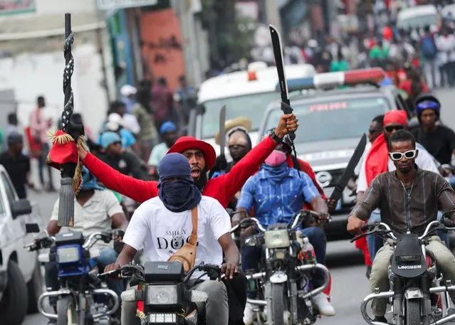 Opposition activist Marcelin Myrthil AKA Arab holds up a machete during a protest against the government, calling for the resignation of Prime Minister Ariel Henry, in Port-au-Prince, Haiti on February 5, 2024. (Photo by Ralph Tedy Erol/Reuters)