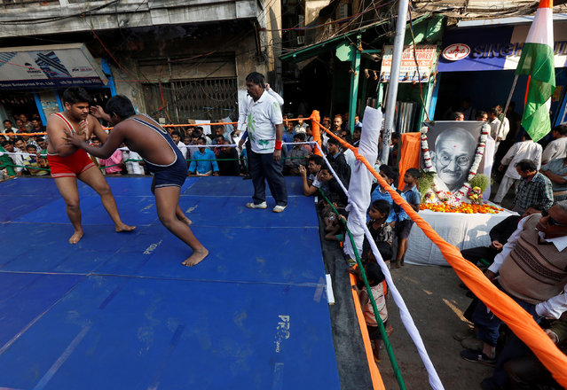 Wrestlers fight during an amateur wrestling championship inside a makeshift ring installed on a road, organized by a non-governmental organization to pay tribute to Mahatma Gandhi on his death anniversary, in a wholesale market area in Kolkata, India, January 30, 2017. (Photo by Rupak De Chowdhuri/Reuters)
