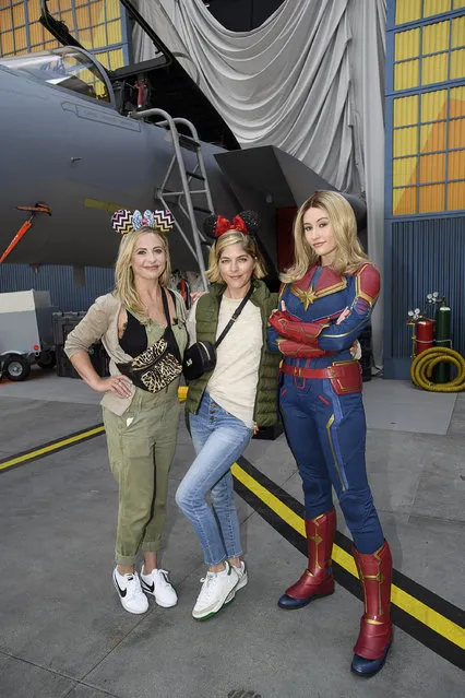 In this handout photo provided by Disneyland Resort, actresses and friends Sarah Michelle Gellar (left) and Selma Blair share a special moment with Captain Marvel at Disney California Adventure Park on March 28, 2019 in Anaheim, California. The friends were celebrating over 20 years of friendship while visiting Disneyland Resort. (Photo by Richard Harbaugh/Disneyland Resort via Getty Images)