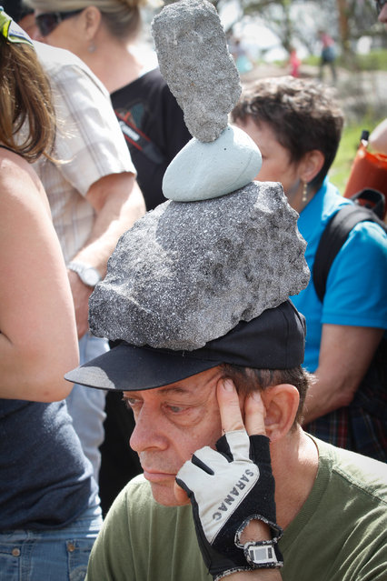 Robert Santa of Fredericksburg, TX watches the balance competition at the Llano Environmental Arts Festival Saturday March 12, 2016. His unique ball cap captured the spirit of the festival. (Photo by Nell Carroll/American-Statesman)