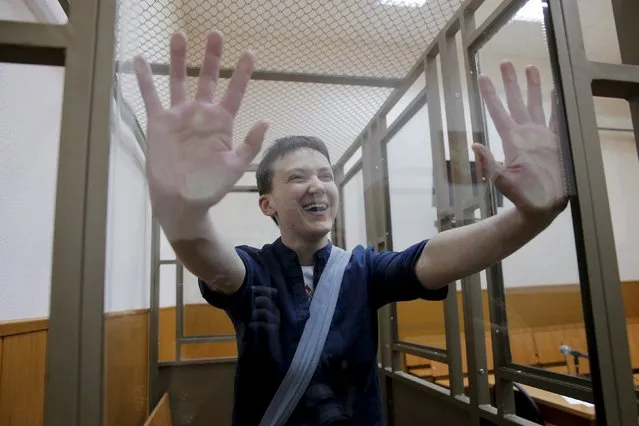 Former Ukrainian army pilot Nadezhda Savchenko gestures from inside a glass-walled cage during a verdict hearing at a court in the southern border town of Donetsk in Rostov region, Russia, March 21, 2016. (Photo by Maxim Shemetov/Reuters)