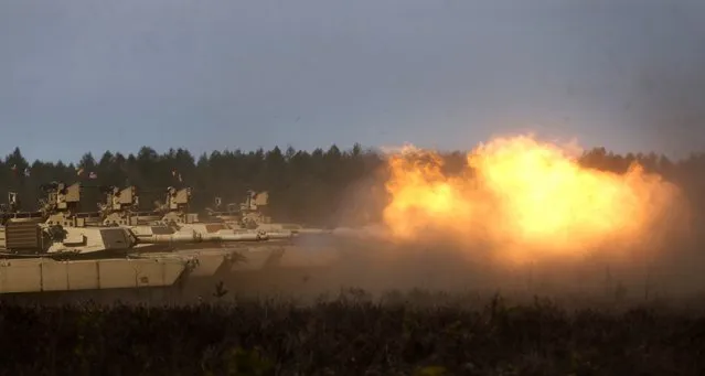 U.S. soldiers from the 2nd Battalion, 1st Brigade Combat Team, 3rd Infantry Division fire their M1A2 Abrams battle tank during a military exercise at the Gaiziunu Training Range in Pabrade some 60km (38 miles) north of the capital Vilnius, Lithuania, Thursday, April 9, 2015. (Photo by Mindaugas Kulbis/AP Photo)