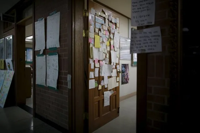 Messages to victims who were onboard sunken ferry Sewol, are attached on a door of an empty classroom, which was preserved since the disaster, at Danwon high school during the second anniversary of the disaster in Ansan, South Korea, April 16, 2016. (Photo by Kim Hong-Ji/Reuters)