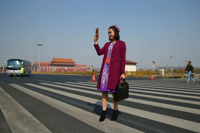 A delegate stands outside of the Great Hall of the People before the opening session of the Chinese People's Political Consultative Conference (CPPCC) in Beijing, China, March 3, 2017. (Photo by Thomas Peter/Reuters)