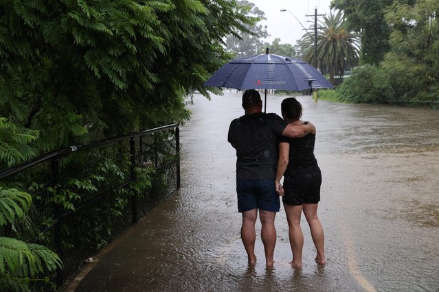 Local residents look in the direction of their flooded home as the state of New South Wales experiences widespread flooding and severe weather, in Sydney, Australia, March 21, 2021. (Photo by Loren Elliott/Reuters)