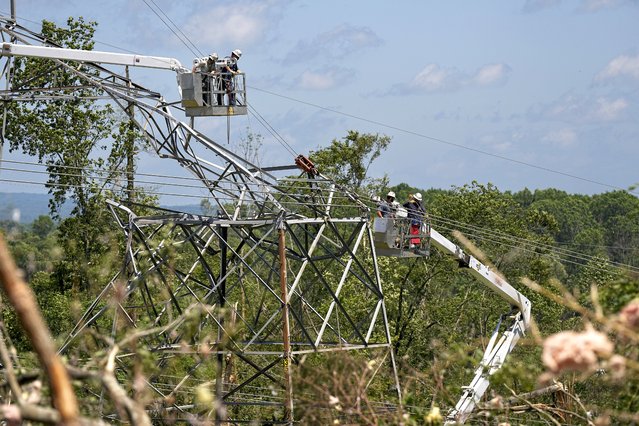 Utility workers repair a TVA tower Thursday, May 9, 2024, in Columbia, Tenn. A wave of dangerous storms began crashing over parts of the South on Thursday, a day after severe weather with damaging tornadoes killed several people in the region. (Photo by George Walker IV/AP Photo)