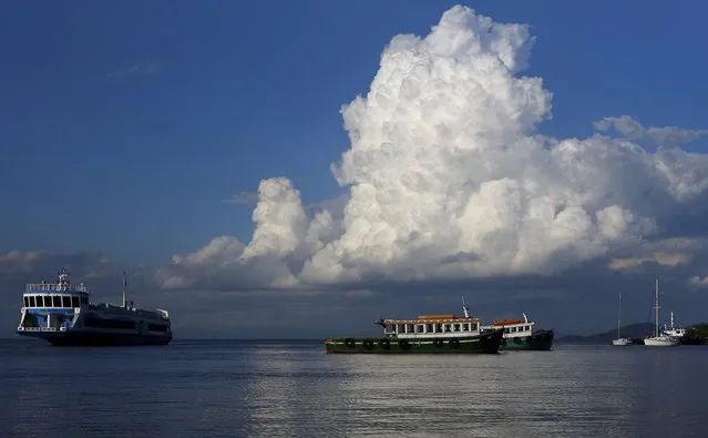 A ferry (L) arrives at Paqueta island in Guanabara Bay in Rio de Janeiro Brazil, April 13, 2016. According to the concessionaire 110,000 passengers travel on the ferries, which connect neighborhoods and cities surrounded by the Guanabara Bay to Rio de Janeiro's downtown, per day. (Photo by Ricardo Moraes/Reuters)