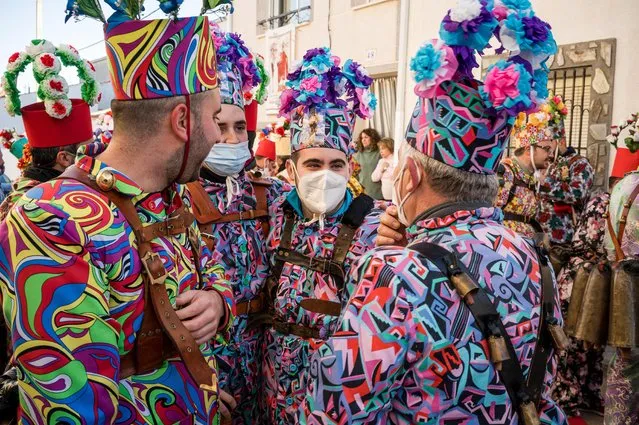 People take part in the Endiablada (demonic) tradition in Almonacid del Marquesado, Cuenca, Spain on February 02, 2022. Every year on February 1, 2, and 3, in honor of the Candelaria and San Blas, a festival is held. The only year in history when the ritual was not observed was 2021, when the COVID-19 pandemic struck. During 100 "devils," dressed in vividly colored costumes and carrying gigantic bells (some weighing more than 20 kilos) on their backs, parade through the streets of the town, carrying the Saints in procession, and dedicate dances and jumps to them over the course of the three-day event. Dances and dances are performed by women dressed in traditional attire. This festival has been designated as a national tourist attraction in Spain. (Photo by Diego Radames/Anadolu Agency via Getty Images)