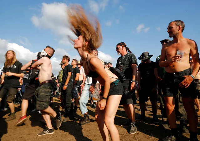 A festivalgoer does “head banging” during the performance of German death metal band Damnation Defaced at the world's largest heavy metal festival, the Wacken Open Air 2019, in Wacken, Germany on August 3, 2019. (Photo by Wolfgang Rattay/Reuters)