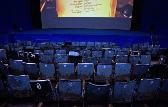 In this Tuesday, March 28, 2017 photo, seats are seen empty before the final movie screening at Regal Theater in New Delhi, India. From Bollywood superstars to political heavyweights, the Regal theater had hosted some of India’s biggest names over more than eight decades. But with nostalgic theater-goers singing their way to the exits after a final showing of a Bollywood classic, the iconic New Delhi theater has closed its doors to make way for a multiplex. (Photo by Manish Swarup/AP Photo)