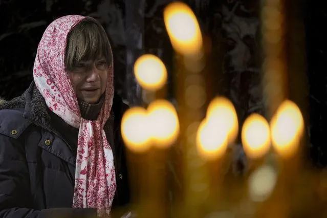 A woman cries during a religious service at the St Volodymyr's Cathedral in Kyiv, Ukraine, Sunday, March 6, 2022. (Photo by Vadim Ghirda/AP Photo)