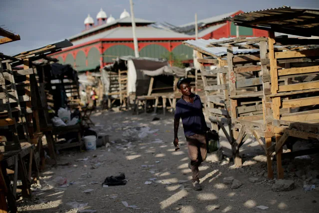 A shoe shiner walks in a street market in Port-au-Prince, Haiti, February 14, 2017. (Photo by Andres Martinez Casares/Reuters)