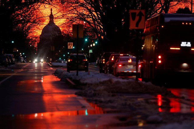 The sunset lights up the sky behind the U.S. Capitol dome on the eve of the first anniversary of the January 6th attack on the Capitol, in Washington, U.S. January 5, 2022. (Photo by Jonathan Ernst/Reuters)