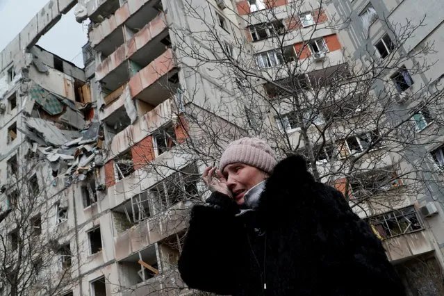 A woman reacts while speaking near a block of flats, which was destroyed during Ukraine-Russia conflict in the besieged southern port city of Mariupol, Ukraine on March 17, 2022. (Photo by Alexander Ermochenko/Reuters)