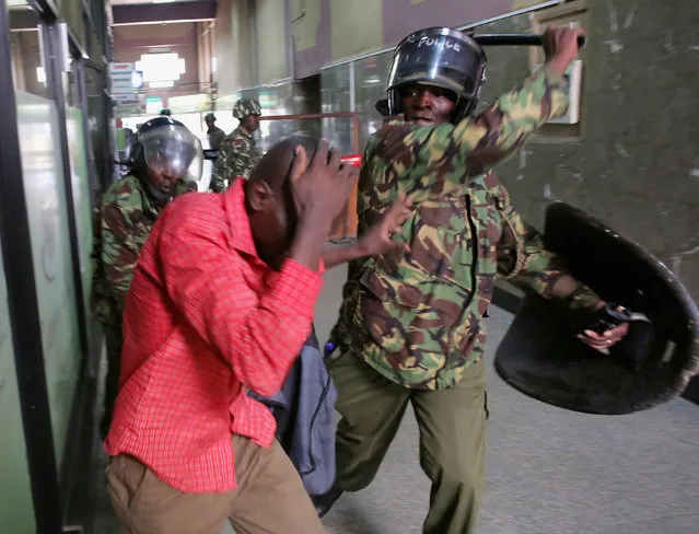 Policemen beat a protester inside a building during clashes in Nairobi, Kenya May 16, 2016. (Photo by Goran Tomasevic/Reuters)