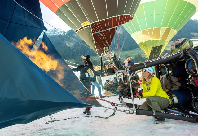 Pilot Amanda Brodbeck prepares her balloon during the 44th International Hot Air Balloon Festival in Chateau-d'Oex, Switzerland on January 25, 2024. (Photo by Denis Balibouse/Reuters)