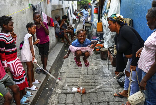 A girl plays a jump rope game at a school housing residents displaced by gang violence in Port-au-Prince, Haiti, Wednesday, May 15, 2024. (Photo by Ramon Espinosa/AP Photo)