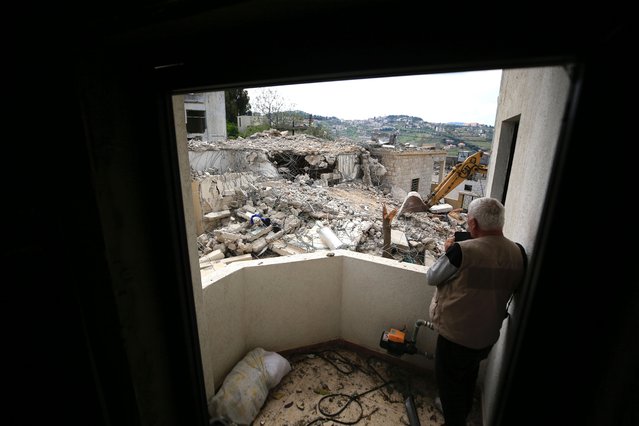 A journalist takes pictures of damaged buildings after an Israeli airstrike in Sultaniyeh region of Southern Lebanon, 08 April 2024. The Israeli military announced that an airstrike by Israeli jets during the night had killed Hezbollah commander Ali Ahmed Hussein, in the Sultaniyeh region of southern Lebanon on 08 April. (Photo by EPA/EFE/Stringer)