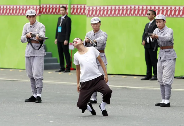 Performers re-enact the 1947 massacre of Taiwanese intellectuals by mainland China's Nationalists troops during the inauguration ceremony of Taiwan's President Tsai Ing-wen in Taipei, Taiwan, Friday, May 20, 2016. (Photo by Chiang Ying-ying/AP Photo)