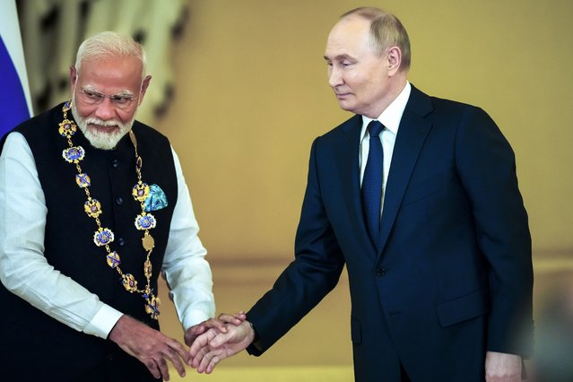 Russian President Vladimir Putin, right, shakes hands with Indian Prime Minister Narendra Modi after awarding him with the Order of St. Andrew the Apostle the First-Called at the Kremlin in Moscow, Russia, Tuesday, July 9, 2024. (Photo by Alexander Zemlianichenko/AP Photo)