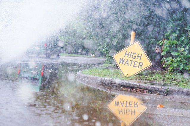 Drivers drive past a high water sign on Abercorn St. on August 6, 2024 in Savannah, Georgia. Tropical Storm Debby has stalled over the South East it is predicted to drop 10-20 inches in the next couple days. (Photo by Megan Varner/Getty Images)