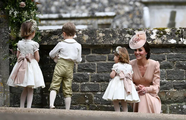 Britain's Catherine, Duchess of Cambridge stands with her daughter Princess Charlotte, a bridesmaid, following the wedding of her sister Pippa Middleton to James Matthews at St Mark's Church in Englefield, west of London, on May 20, 2017. (Photo by Justin Tallis/Reuters)