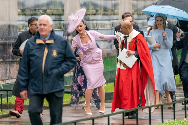 American singer-songwriter Katy Perry stumbles as she leaves Westminster Abbey following the coronation ceremony of King Charles III and Queen Camilla in central London on May 6, 2023. The set-piece coronation is the first in Britain in 70 years, and only the second in history to be televised. Charles will be the 40th reigning monarch to be crowned at the central London church since King William I in 1066. Outside the UK, he is also king of 14 other Commonwealth countries, including Australia, Canada and New Zealand. Camilla, his second wife, will be crowned queen alongside him, and be known as Queen Camilla after the ceremony. (Photo by Jane Barlow/Pool via AFP Photo)