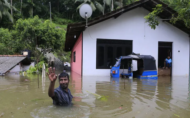 A Sri Lankan wades through floodwater at Agalawatte in Kalutara district, Sri Lanka, Saturday, May 27, 2017. Sri Lanka has appealed for outside help as dozens were killed in floods and mudslides and dozens others went missing. (Photo by Eranga Jayawardena/AP Photo)