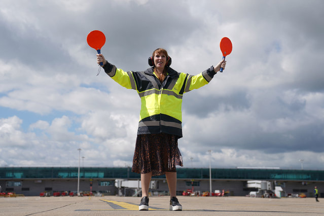 Labour Party deputy leader Angela Rayner marshals an easyJet plane arriving from Amsterdam onto the stand during a visit to London Stansted airport, in Essex, while on the General Election campaign trail on Wednesday, May 29, 2024. (Photo by Joe Giddens/PA Images via Getty Images)