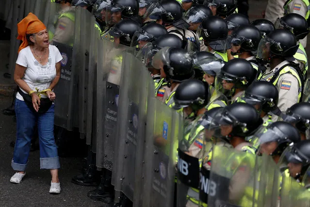 An opposition supporter shouts in front of riot policemen during a rally to demand a referendum to remove President Nicolas Maduro in Caracas, Venezuela, June 7, 2016. (Photo by Carlos Garcia Rawlins/Reuters)