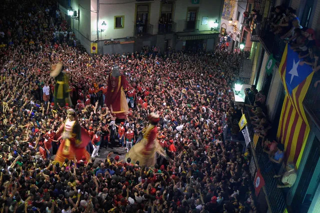 Revelers take part in a traditional party named “La Patum” on June 15, 2017 in Berga, Spain. The Patum of Berga, or simply “La Patum”, is a popular and traditional festival which is celebrated each year in the Catalan city of Berga during the Solemnity of Corpus Christi. It consists of several performances of mystical and symbolic figures that dance to the rhythm of a big drum and vivid music. It also includes fire and pyrotechnics. “La Patum” was declared as “Traditional Festival of National Interest” by the autonomous government of Cataluna in 1983, and as a “Masterpiece of the Oral and Intangible Heritage of Humanity” by UNESCO in 2005. (Photo by Lluis Gene/AFP Photo)
