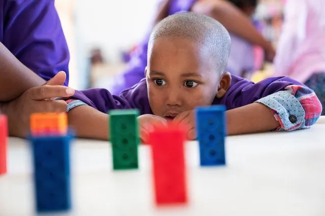 A child in the SmartStart national early learning programme engages in an activity at the SmartStart center in the farm working community of De Doorns, South Africa 31 March 2022. (Photo by Nic Bothma/EPA/EFE)