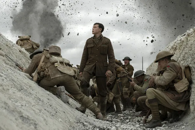 This image released by Universal Pictures shows George MacKay, center, in a scene from “1917”, directed by Sam Mendes. (Photo by François Duhamel/Universal Pictures via AP Photo)