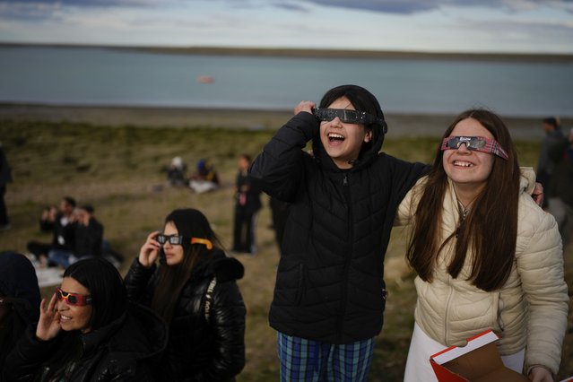 People watch an annular solar eclipse in Puerto San Julian, Argentina, Wednesday, October 2, 2024. (Photo by Natacha Pisarenko/AP Photo)