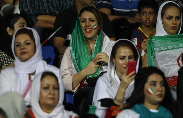 In this September 8, 2015 file photo, Iranian women watch the 2018 FIFA World Cup qualifying soccer match between Iran and India in Bangalore, India.   Iranian women are being denied their place inside sports venues again, with no way to watch their Olympic-bound men’s volleyball team in person during this weekend’s high-profile World League matches in Tehran. Despite assurances from volleyball’s world governing body that women would be allowed to attend the tournament that began Friday, July 1, 2016, at the Azadi Sport Complex, Iranian women say they haven’t been able to purchase tickets. (Photo by Aijaz Rahi/AP Photo)