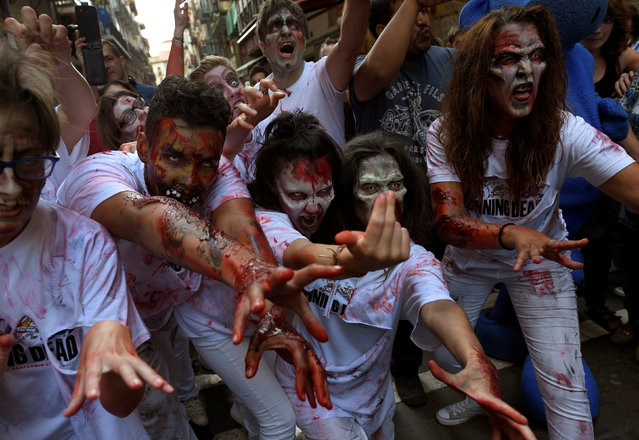 Revellers dressed as zombies take part in an enactment of the running of the bulls a day before the start of the San Fermin festival in Pamplona, northern Spain, July 5, 2016. (Photo by Eloy Alonso/Reuters)
