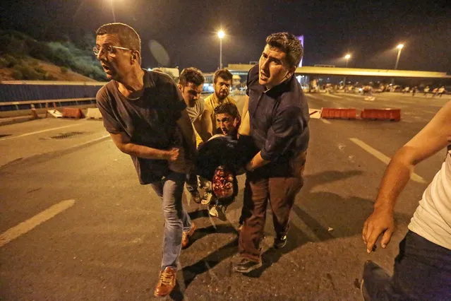 A man shot during clashes with the military is carried away from the entrance to the Bosphorus bridge on July 16, 2016 in Istanbul, Turkey. (Photo by Gokhan Tan/Getty Images)