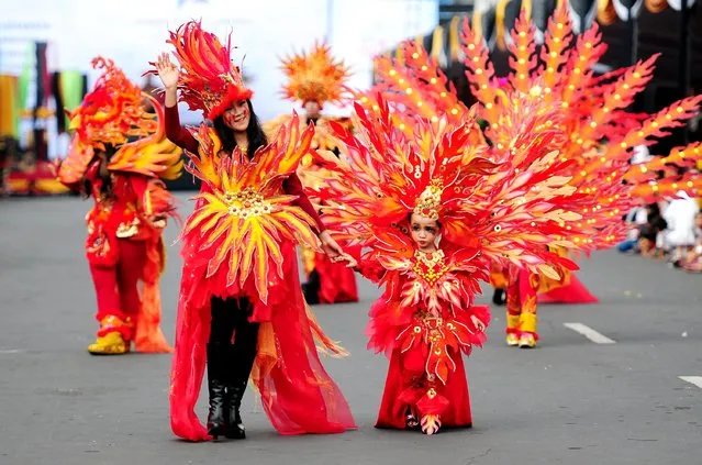 Models wear Phoenix costumes in the kids carnival during The 13th Jember Fashion Carnival 2014 on August 21, 2014 in Jember, Indonesia. (Photo by Robertus Pudyanto/Getty Images)