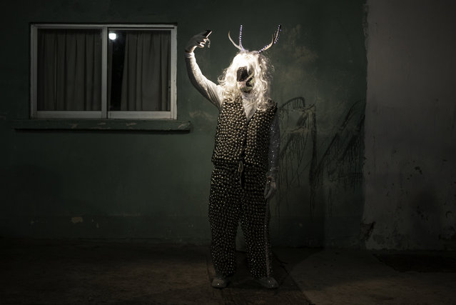 A man poses for a photo wearing a costume during a Muerteada parade in San Agustin Etla, Thursday, November 2, 2023. Mexicans in the Oaxacan town celebrate the traditional Muerteada, a theatrical recreation that is performed through the night of November 1 until the early morning of the following day, with dances and music parading through the streets, while telling the story of how a deceased person is resurrected with the help of a priest, a doctor and a spiritist. (Photo by Maria Alferez/AP Photo)