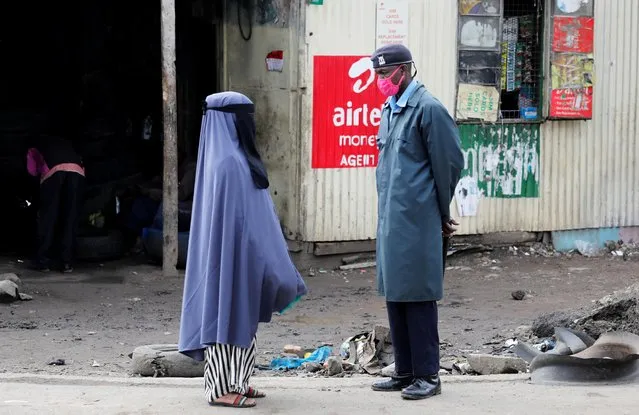 A woman talks with a police officer, after the government announced a lockdown of Nairobi's storied Eastleigh district and the Old Town of Mombasa for two weeks following a jump in confirmed coronavirus disease (COVID-19) cases there, Nairobi, Kenya on May 7, 2020. (Photo by Baz Ratner/Reuters)