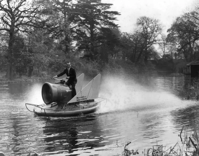 Carl Mikan, chief engineer of the Hover Scooter project, pilots the vehicle over water at Long Ditton, Surrey, 9th November 1960. The scooter rides on a six inch cushion of air and is driven by a 250cc twin cylinder two stroke motor cycle engine. (Photo by Harry Todd/Fox Photos)