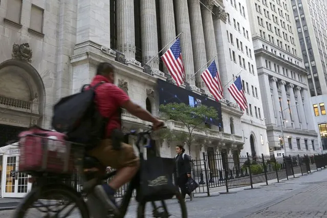 A man bikes past the New York Stock Exchange, Wednesday, September 21, 2022, in New York. Stocks are off to a modestly higher start on Wall Street ahead of a widely expected interest rate increase by the Federal Reserve. The S&P 500 was up half a percent in the early going Wednesday, as was the Dow Jones Industrial Average. (Photo by Peter Morgan/AP Photo)